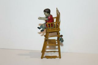 EARLY 1900 ' s GERMAN TIN LITHO CHILD IN HIGH CHAIR PENNY TOY 2