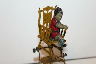 EARLY 1900 ' s GERMAN TIN LITHO CHILD IN HIGH CHAIR PENNY TOY 7