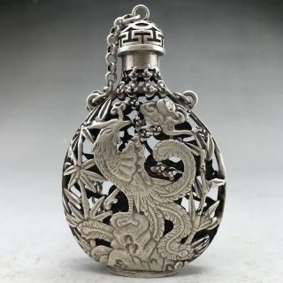 A phoenix image of a silver snuff bottle carved by hand in ancient Tibet 2