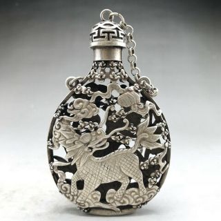 A phoenix image of a silver snuff bottle carved by hand in ancient Tibet 4