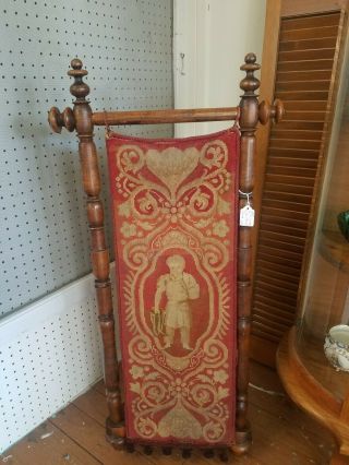 Antique Standing Bootjack With Tapestry Of Man Holding Boots