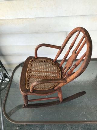 vintage antique childs wooden rocking chair with wicker bottom 2
