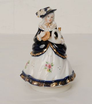 Musical Figurine Of Woman Wearing Period Blue Floral Dress