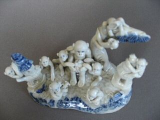 An unusual Chinese porcelain Monkey Troupe,  in human positions.  Late 19th C/ Re 7