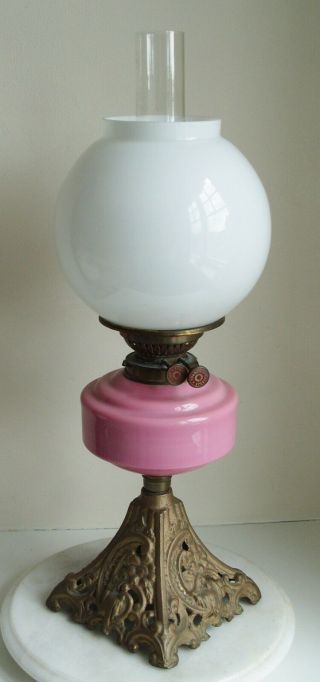 Vintage Youngs Oil Lamp with pink glass bowl and white Shade on a cast iron base 2
