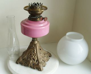 Vintage Youngs Oil Lamp with pink glass bowl and white Shade on a cast iron base 7