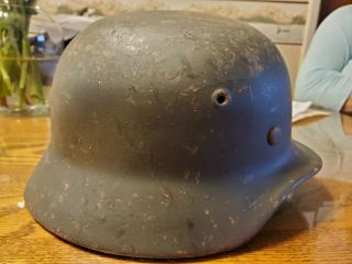 M 40 German helmet with liner.  No chinstrap.  Shows wear.  Stamped EF62. 3