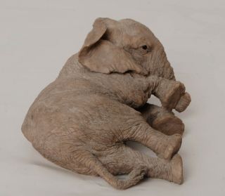 Paw Prints Figurine Of An Elephant Lying Down