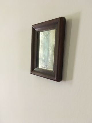 Primitive Small Mirror In Simple Brown Wooden Frame With Mottled And Hazy Glass