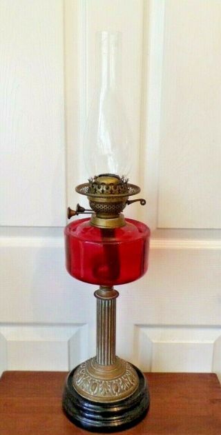 A Victorian Cranberry Glass Font Oil Lamp On Black Glazed Base Order A/f