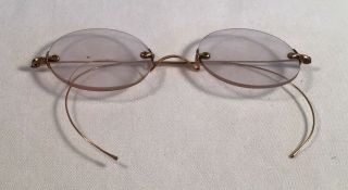 Two vintage spectacles,  one round lens and one octagonal.  Silver and gol 2