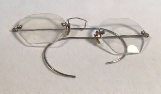 Two vintage spectacles,  one round lens and one octagonal.  Silver and gol 3