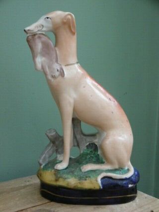 19thc Staffordshire Greyhound In Sitting Pose With Rabbit In Mouth