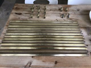 Set Of 13 Brass Stair Rods With Matching Folding Brackets.
