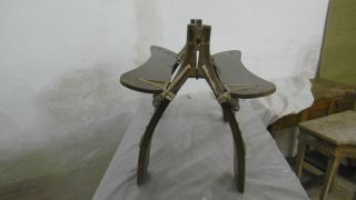 Vintage wooden camel saddle stool with decorative brass studs and emblems 2