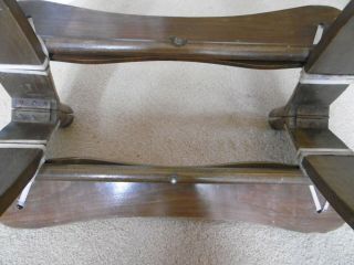 Vintage wooden camel saddle stool with decorative brass studs and emblems 4