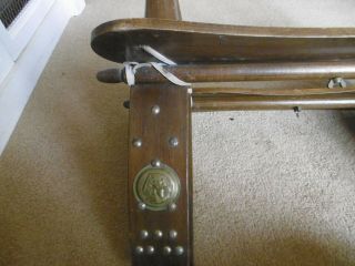 Vintage wooden camel saddle stool with decorative brass studs and emblems 7
