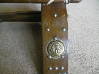 Vintage wooden camel saddle stool with decorative brass studs and emblems 8