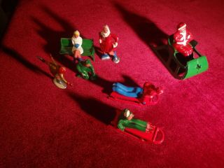 VINTAGE SET OF CAST IRON SANTA on a SLEIGH,  ICE SKATING FIGURES AND SLED RIDERS 7