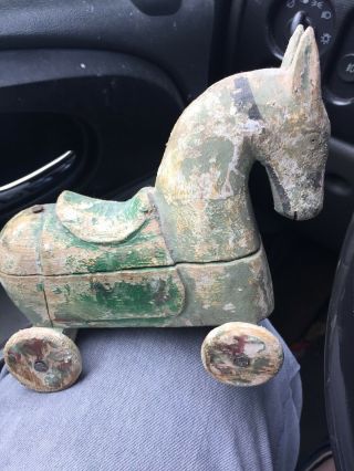 Folk Art Carved Wooden Horse On Wheels With Storage Compartment.