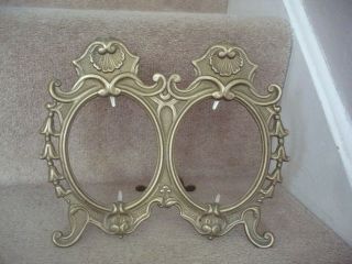 An Art Nouveau Brass Ornate Double Oval Photograph Frame