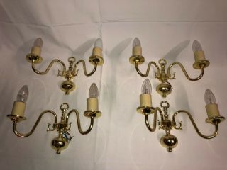 A Set Of Four Elegant Two Arm Brass Wall Sconces