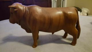 2 Hand Carved Wooden Bulls.  One If The Tails Broke Off But I Glued It Back On