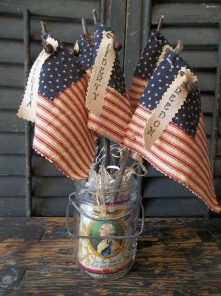 Gathering Of Primitive Handmade Americana Flags In Vintage Glass Atlas Jar