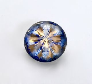 Small Speckled Blue Kaleidoscope Button With A Gold Floral Design.