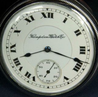 A 47.  HAMPDEN 16 SIZE 17 J 2 TONE MOVEMENT,  D.  S.  PORCELAIN DIAL IN A DISPLAY C 3