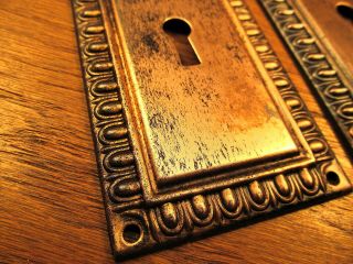 PAIR OLD STAMPED BRASS PLATED DOOR KNOB BACKPLATES.  ESCUTCHEONS. 3