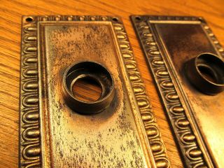 PAIR OLD STAMPED BRASS PLATED DOOR KNOB BACKPLATES.  ESCUTCHEONS. 5