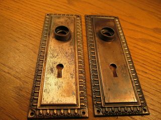 PAIR OLD STAMPED BRASS PLATED DOOR KNOB BACKPLATES.  ESCUTCHEONS. 8