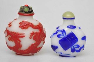 Two Chinese Overlay White Peking Glass Snuff Bottles.  Red Dragon And Blue Book