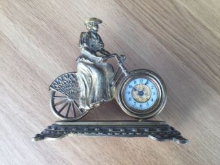 Lady on bicycle by British united.  Clock co.  Ltd. 2