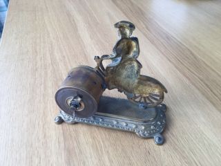 Lady on bicycle by British united.  Clock co.  Ltd. 3