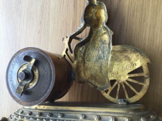 Lady on bicycle by British united.  Clock co.  Ltd. 5