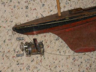 Early pond boat with fishing reel. 2