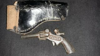 100 year old cast Iron Pluck Cap Gun.  Cow hair holster perfectly. 5