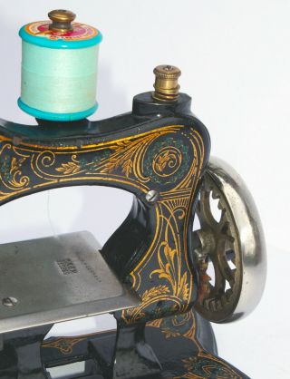 Antique cast - iron toy/miniature sewing machine 5