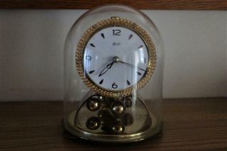A Vintage German Kundo Torsion Clock Under Glass Dome Order