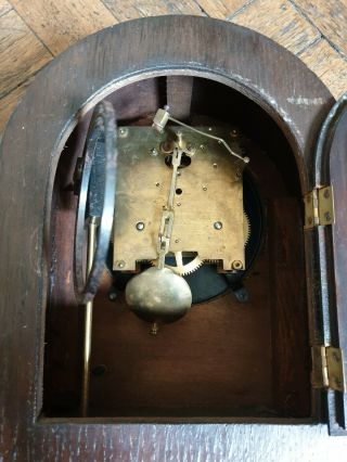 vintage wooden mantle clock with key ticks,  chimes but movement needs a 4