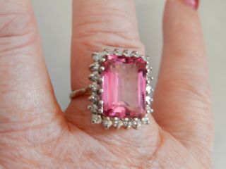 A FABULOUS 9 CT GOLD STEP CUT 10.  00 CARAT PINK GEMSTONE AND DIAMOND RING 9