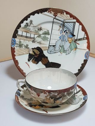 A Meiji Period Kutani Eggshell Cup,  Saucer & Plate.  Trio.  47 Ronin.  Signed.