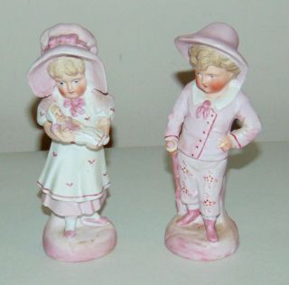 Antique Victorian Bisque Girl & Doll Pink Boy & Toy Gun Figurines