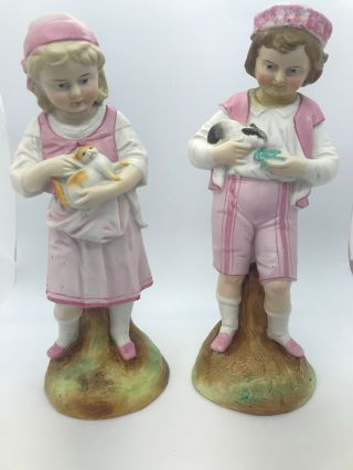 Antique German Bisque Figurine Of Boy & Girl Holding Cat And Rabbit 10” Inches