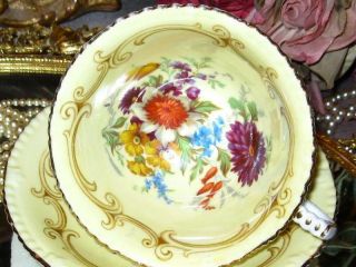 PARAGON YELLOW TEACUP & SAUCER FLORAL CENTER FANCY FOOTED DOUBLE WARRANT 2