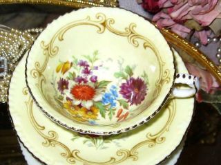 PARAGON YELLOW TEACUP & SAUCER FLORAL CENTER FANCY FOOTED DOUBLE WARRANT 4