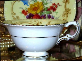PARAGON YELLOW TEACUP & SAUCER FLORAL CENTER FANCY FOOTED DOUBLE WARRANT 7