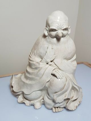 A Chinese Ming/qing Dynasty White Glazed Porcelain Figure Of An Immortal.